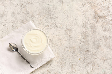 Glass bowl of tasty yogurt on white background
