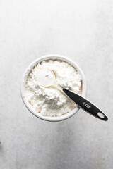 overhead view of All purpose flour in a bowl, top view of baking flour in a ceramic bowl