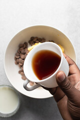 Overhead view of cup with coffee on a white background