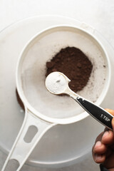 Overhead view of baking soda or baking powder in a measuring spoon, A teaspoon of baking soda or baking powder