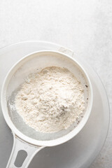 Overhead view of white sugar in a bowl, top view of granulated sugar in a ramekin
