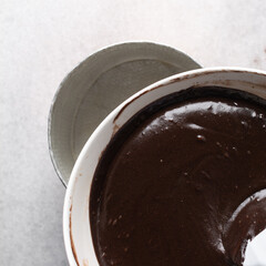 Overhead view of dark chocolate mud cake batter in a mixing bowl, process of making chocolate mud cake, making a dark chocolate cake