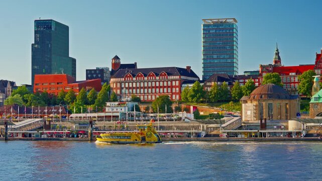 View of Hamburg's waterfront and citycenter and ships and boats passing along the Elbe River at sunset in Hamburg, Germany