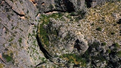 Obraz premium Aerial view of the narrow gorges and ravines created by the Amadorio River as it passes through the village of Relleu, Spain.