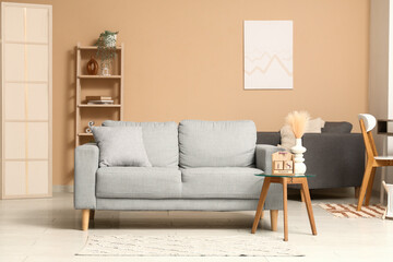 Interior of living room with grey sofa and calendar on table