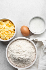 Overhead view of mise en place of ingredients used to make tart shell dough, top view of items used to make pie crust dough