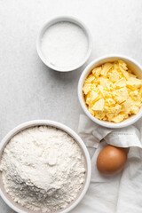Overhead view of mise en place of ingredients used to make tart shell dough, top view of items used to make pie crust dough