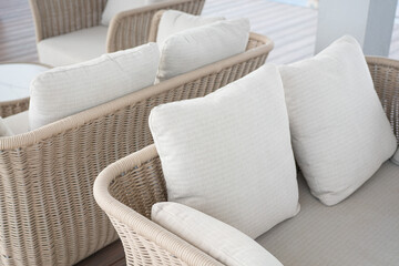 Wicker Chairs with White Pillows. 