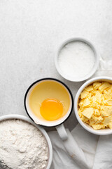 Overhead view of mise en place of ingredients used to make tart shell dough, top view of items used to make pie crust dough