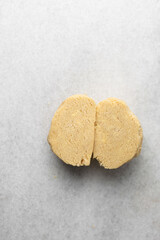 overhead view of tart shell dough on granite countertop, top view of pie shell dough, process of making tart