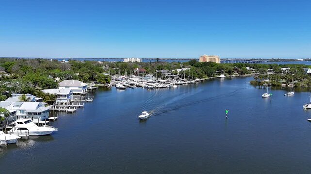 Boat returning to the Eau Gallie Yacht Harbor basin behind Ballard Park along the Indian River in Brevard County in Melbourne, Florida. 