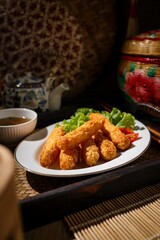 Fried breaded shrimps in white plate