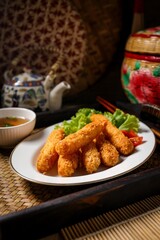 Fried breaded shrimps in white plate