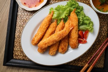 Fried breaded shrimps in white plate