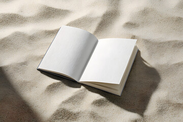 Open blank book on textured sand, perfect for travel stories, creative writing, or summer memories