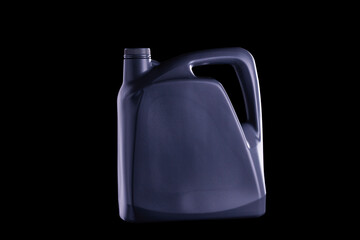 Black oil gallon or lubricant barrel or motor oil bottle isolated on black and dark background.