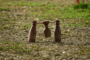 wooden bottle for petanque sport Thai style, equipment on green grass