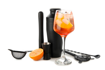 Glass of Aperol spritz cocktail and bartender tools isolated on white background
