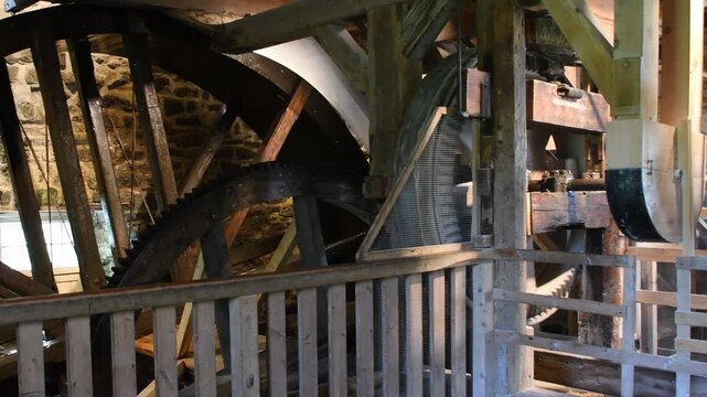Waterwheel of a flour watermill. Traditional mechanical wooden wheel and gear.
