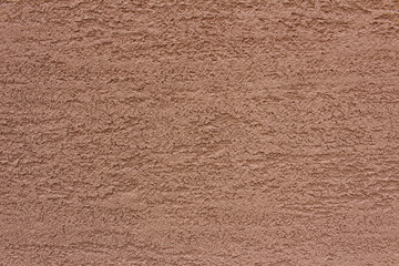 Fototapeta premium Rough surface of brown concrete wall background. Uneven cement wall texture.