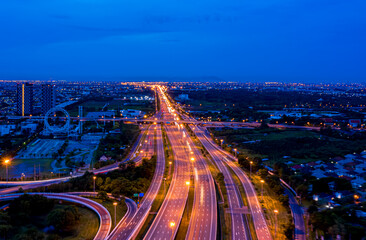 Morden city and smart transportation with Expressway, Road and Roundabout, busy highway traffic night time. Important infrastructure.