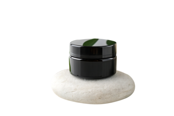 a sleek black cosmetic jar placed on a smooth stone naturally