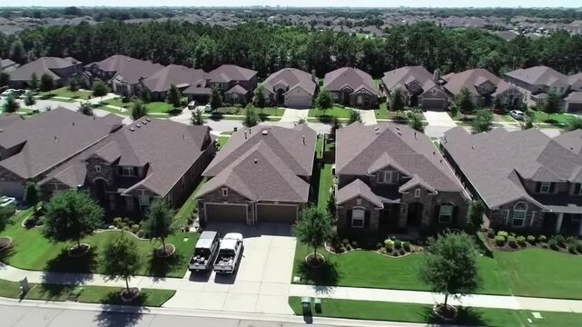 Aerial view of a suburban residential neighborhood in Stockton, California, showcasing rows of single-family homes, streets, and surrounding farmland. Ideal for topics related to urban planning, Calif