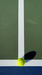 Minimal top down tennis court geometry with tiny ball casting a long shadow at the line intersection, bold color blocks and generous copy space