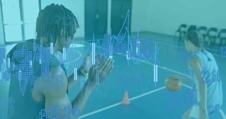 Coach clapping initiating basketball drill with athlete dribbling cones while tech data updating - Powered by Adobe