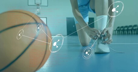 Kneeling female athlete lacing basketball shoe and activating network overlay for sports data - Powered by Adobe