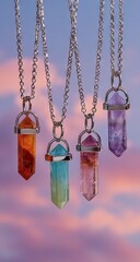 Colorful gemstone pendants hanging from silver chains.