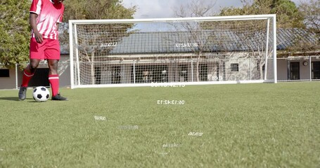 Soccer player tapping ball and dribbling toward goal via data overlay displaying sports stats drill - Powered by Adobe
