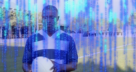 Male athlete on field holding rugby ball, digital code cascading sparking rotation and pulsing toss - Powered by Adobe