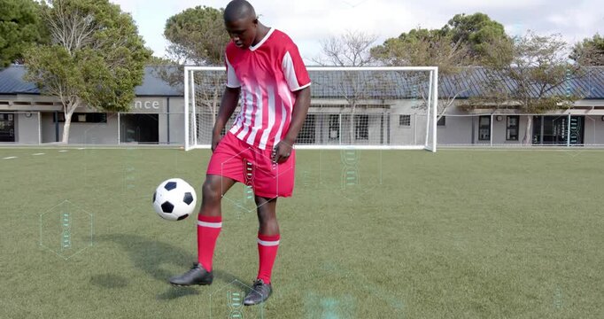 Tapping ball down male soccer player juggling ball on pitch with sports HUD analyzing control data - Powered by Adobe