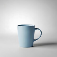 Fototapeta premium A light gray background highlights a simple, light-blue mug, showcasing a clean, modern aesthetic.