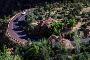 Scenic highway hairpin turn on a sunny summer day in a arid desert southwest environment, cars...