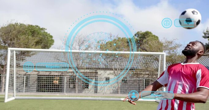 Male soccer player tracking descending ball and monitoring data via pulsing AR interface - Powered by Adobe