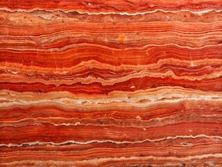 Naklejka premium Abstract red orange and white banded natural stone texture background