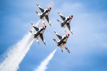 Air show planes flying in formation in blue sky