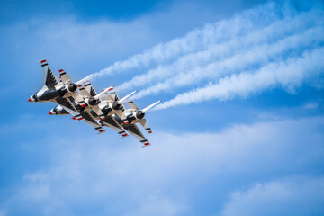 Air show planes flying in formation in blue sky