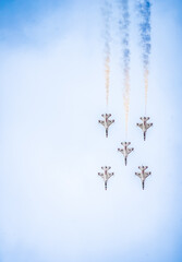 Air show planes flying in formation in blue sky
