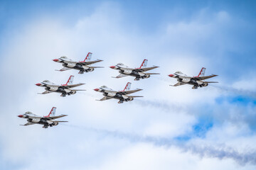 Air show planes flying in formation in blue sky