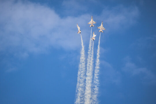 Air show planes flying in formation in blue sky