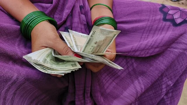 Indian female counting 500 rupees Indian currency notes	