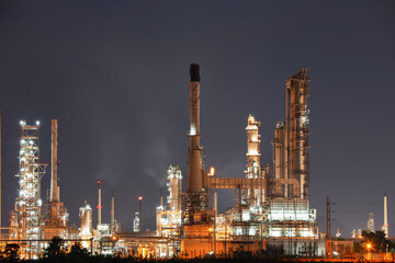 Oil gas refinery plant or petrochemical plant at night. Negative color tone suit for negative concept of price, market. Many machine equipment and pipeline to processing for petrol or fuel production.