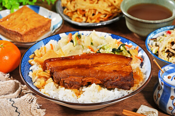 Braised pork belly rice is a beloved Taiwanese dish featuring a thick slice of soy-braised pork belly served over steamed white rice.