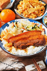 Braised pork belly rice is a beloved Taiwanese dish featuring a thick slice of soy-braised pork belly served over steamed white rice.