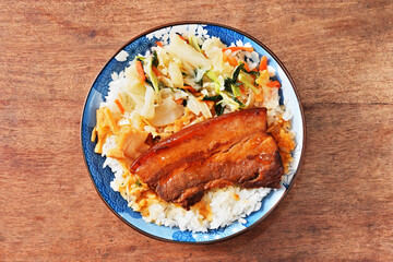 Braised pork belly rice is a beloved Taiwanese dish featuring a thick slice of soy-braised pork belly served over steamed white rice.
