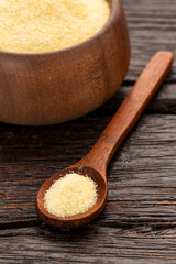 Wheat semolina in a wooden spoon and bowl - Triticum