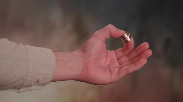 A captivating hand delicately holding a cigarette set against an artistic and intriguing background